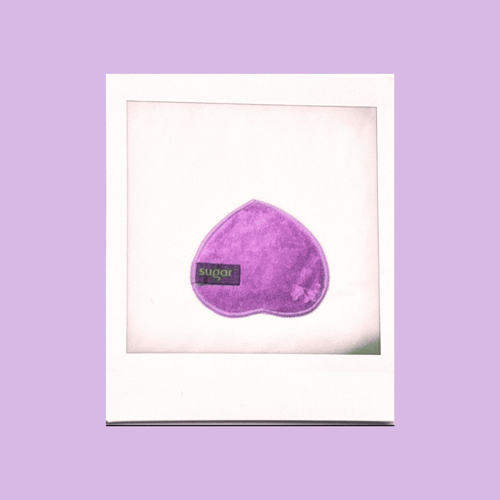 Polaroid of dog nose shaped purple bamboo reusable cleansing wipe.